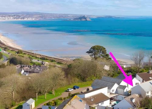 an aerial view of a beach with a pink arrow at Above the Bay - Enclosed garden apartment with parking in Penzance
