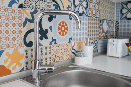 a kitchen sink with a faucet in a kitchen at Marina Studios in Cospicua