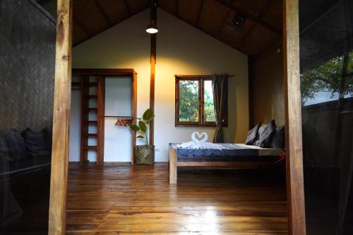 a room with a bed and a window at Fisheye Villa in El Nido
