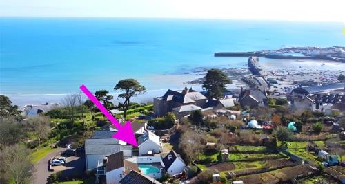 a view of a town with a pink arrow at Above the Bay - Enclosed garden apartment with parking in Penzance