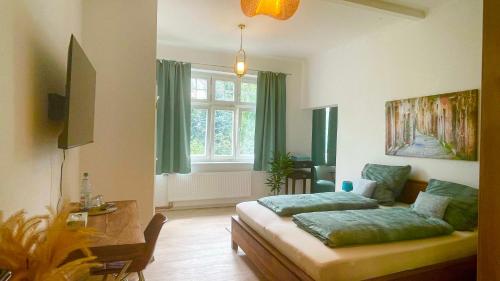 a living room with a bed and a window at Gästehaus Ambiente am Kurpark in Bad Sooden-Allendorf