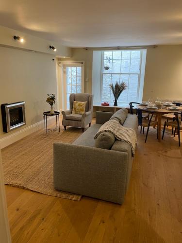 a living room with a couch and a table at Super central Edinburgh Castle basement in Edinburgh