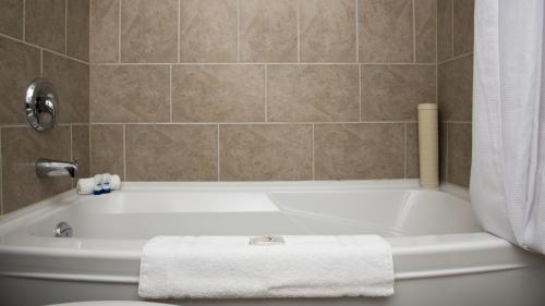 a bathroom with a bath tub with a towel at Valley Star Motel in Penticton