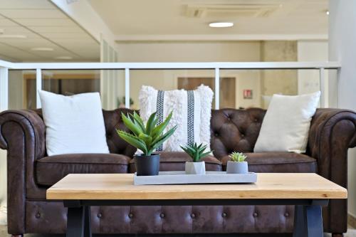 a coffee table in a living room with a couch at Résidence Easy Lodge in Ajaccio