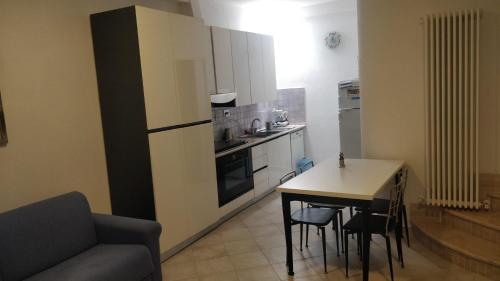 a kitchen with a table and a couch and a table and chairs at Agriturismo Lo Scoiattolo in Ronciglione