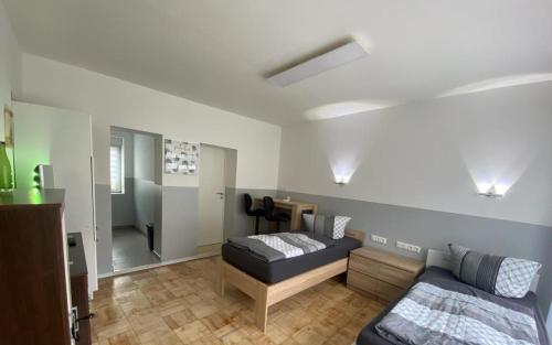 a living room with a bed and a couch at Ferienwohnung H&M Immobilien Hettstedt 2 in Hettstedt