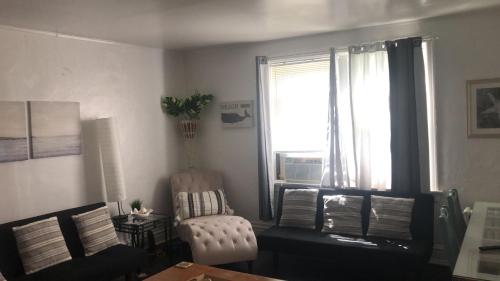 a living room with a chair and a window at (49.1W) Beautiful Getaway in Saint Louis in Saint Louis