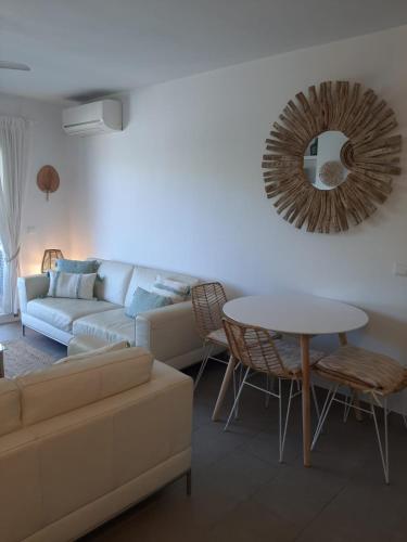 a living room with a couch and a table and a mirror at Beautiful Apartment in Pollença Gotmar in El Port