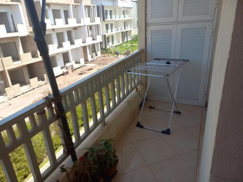 a table on a balcony with a view of a building at Appt Bab Rayane Uniquement pour les familles in Casablanca