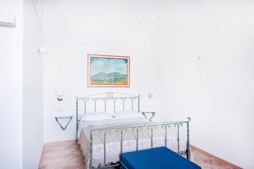 a bedroom with a bed in a white room at Emerald's Resort - Rachele in Conca dei Marini