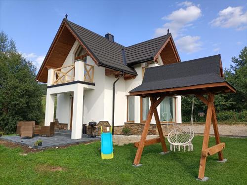 a house with a gazebo in front of it at Modrzewiowa Ostoja in Kluszkowce