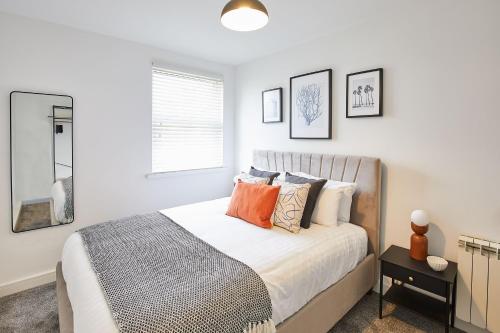 a white bedroom with a bed with pillows at Host & Stay - North Quay Apartments in Seaham