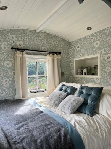 a bedroom with a large bed in front of a window at The Hazel Hut in Westport