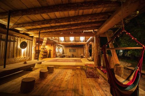 a large wooden room with a hammock in it at Camp Ćuk 