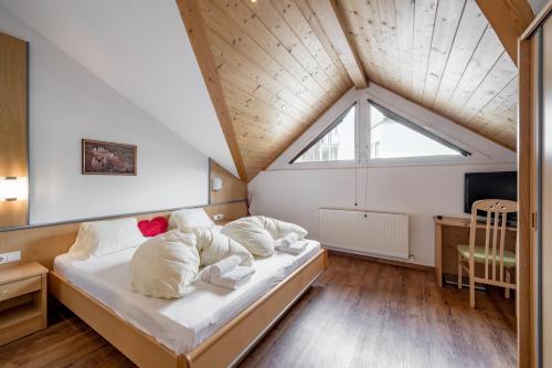 a bedroom with a bed with white sheets and a window at Apart Holiday in Sölden