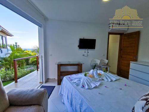a hotel room with a bed and a balcony at SUN7 in Morro de São Paulo