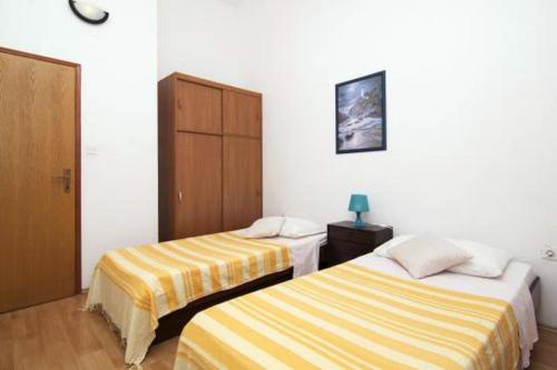 a room with two beds in a room at Apartments with a swimming pool Valbandon, Fazana - 7351 in Fondole