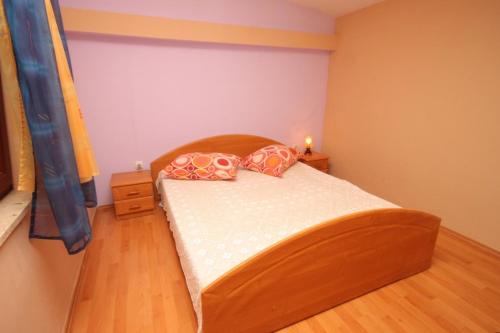 a bedroom with a bed with two pillows on it at Apartments with a parking space Valbandon, Fazana - 7383 in Fondole