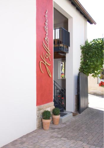 a building with potted plants on the side of it at Ferienhaus & Weingut am Steingebiss in Billigheim-Ingenheim