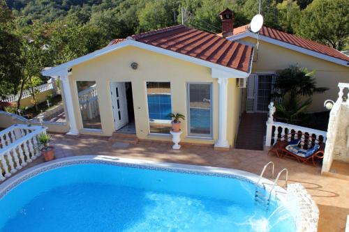 a swimming pool in front of a house at Luxury villa with a swimming pool Ripenda, Labin - 7360 in Labin