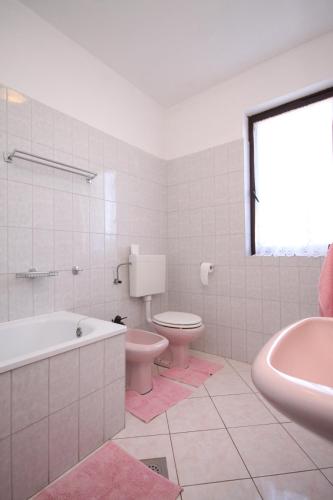 a bathroom with a tub and a toilet and a sink at Apartments with parking space Valbandon, Fazana - 7305 in Valbandon