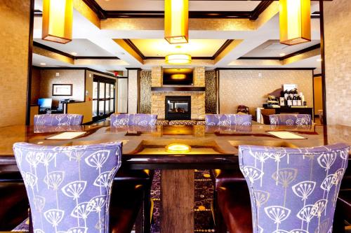 a dining room with a large table and chairs at Holiday Inn Express Hotel & Suites Billings by IHG in Billings