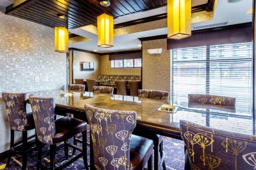 a dining room with a large wooden table and chairs at Holiday Inn Express Hotel & Suites Billings by IHG in Billings