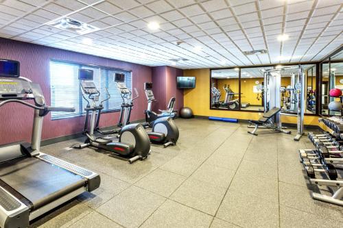 a gym with several treadmills and elliptical machines at Holiday Inn Express Hotel & Suites Billings by IHG in Billings