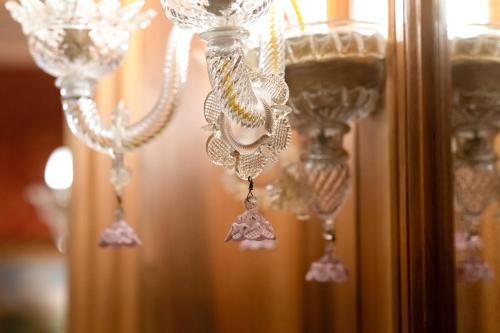 a group of clear glasses hanging from a wall at Hotel Santa Marina in Venice