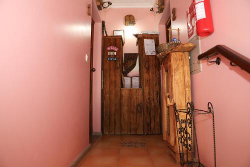 a hallway with a wooden door in a room at Casa na Serra da Estrela in Melo