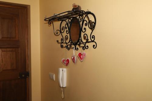 a chandelier with hearts hanging on a wall at Casa na Serra da Estrela in Melo