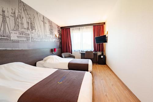 a hotel room with two beds and a tv at Bastion Hotel Rotterdam Zuid in Rotterdam