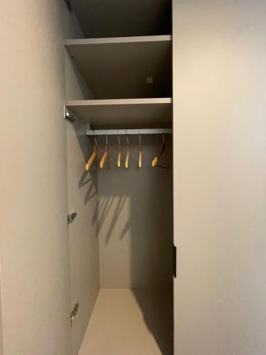 a walk in closet with wooden hangers in it at Hotel Ristorante Tre Lanterne & SPA in Acquasanta Terme