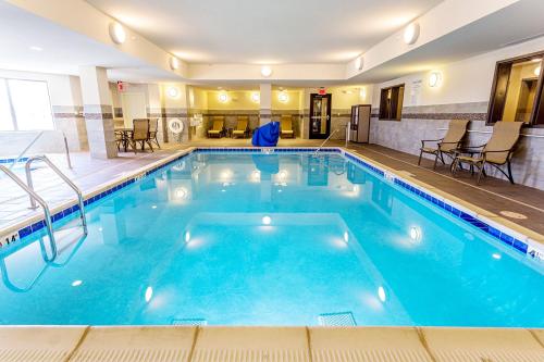 a large pool with blue water in a hotel room at Holiday Inn Express Hotel & Suites Billings by IHG in Billings