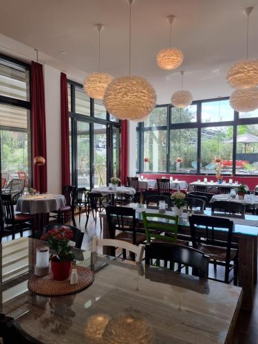 a dining room with tables and chairs and windows at Grimm's Potsdamer Platz in Berlin