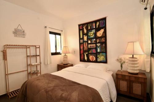 A bed or beds in a room at Hoffman Executive Suites - Beachfront Nahariya