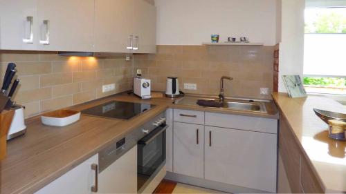 a kitchen with a sink and a counter top at Haus der 5 Kontinente in Böbrach