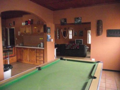 a living room with a pool table in it at Sabie Gypsy's Backpackers in Sabie
