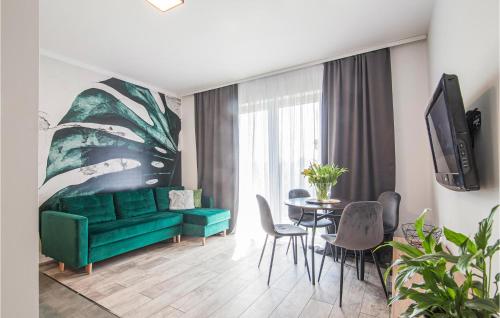 a living room with a green couch and a table at 1 Bedroom Stunning Apartment In Wladyslawowo in Władysławowo