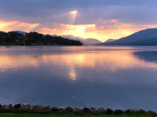 a view of a large body of water at sunset at Linnhe Lochside Holidays in Corpach