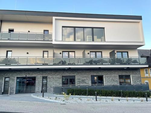 a building with a balcony on the side of it at Hotel Traunfall in Viecht