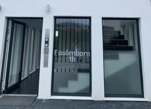 two glass doors of a building with a sign on it at eifel24, neu, modern mit Dachterrasse in Schwirzheim