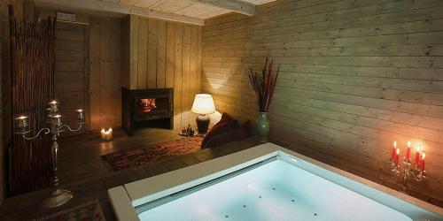 a swimming pool in a room with a fireplace at L'Isola Di Rosa - Relais & Hotel di Charme in Cerveteri