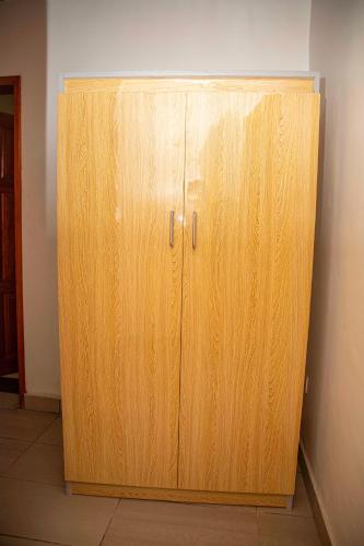 a wooden cabinet in the corner of a room at ORION RESIDENCY BONABERIE in Douala