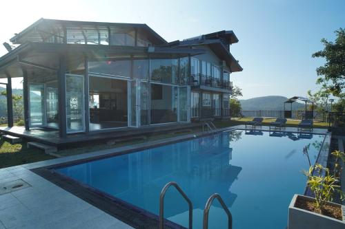 a house with a swimming pool in front of a house at Cinnamon Serenity Villa in Badulla