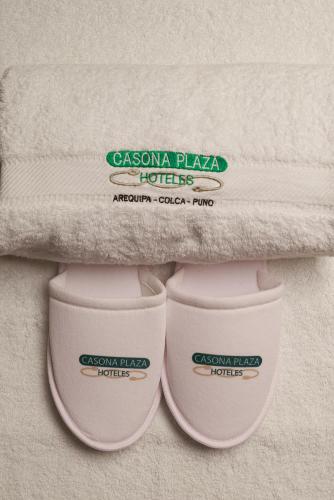 a pair of compression pillows sitting under a towel at Casona Plaza Hotel Colonial in Arequipa