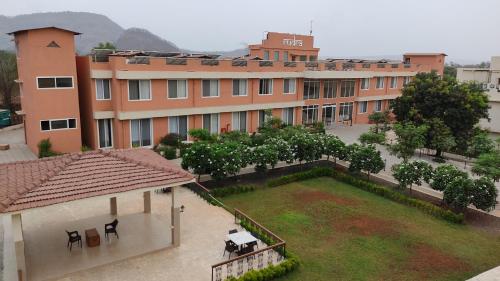 an aerial view of a building with a yard at juSTa Rudra Resort & Spa in Kolād