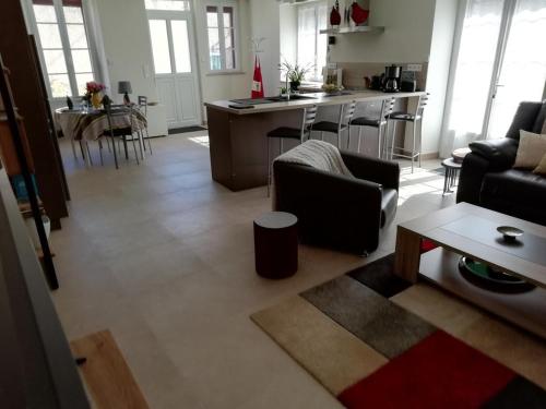 a living room with a couch and a table at Les Prés de Bondus in Chéu