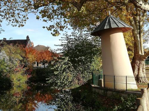 a lighthouse in the middle of a body of water at Les Prés de Bondus in Chéu