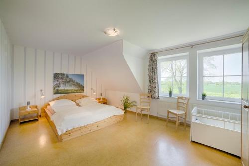 a bedroom with a bed and a large window at "Ferienhof Seelust" Reihenhaus 8 in Gammendorf